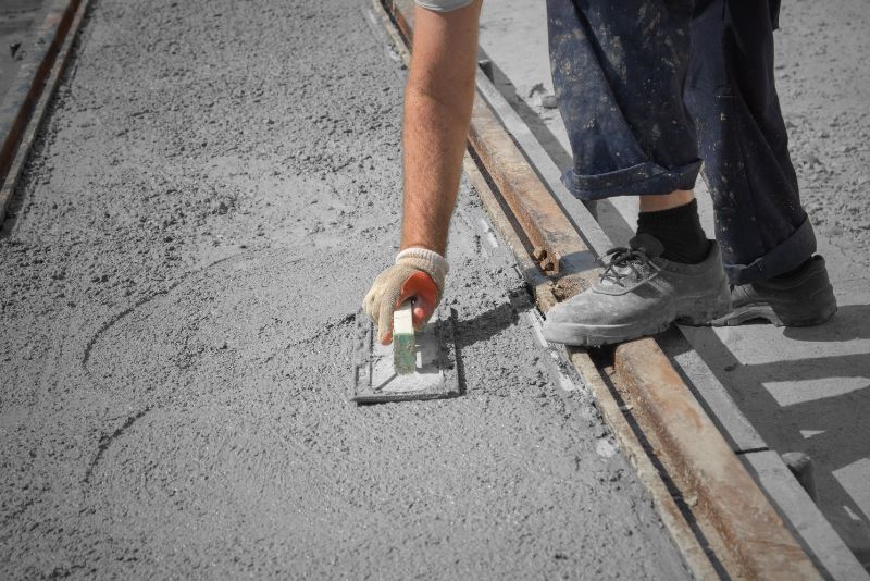 A concrete driveway being laid by pouring concrete mix