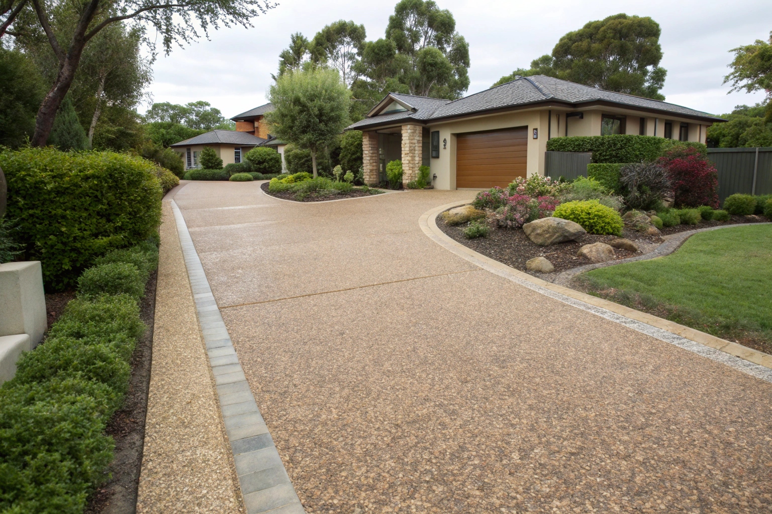 Exposed aggregate concrete driveway with natural river stones in Maryborough home